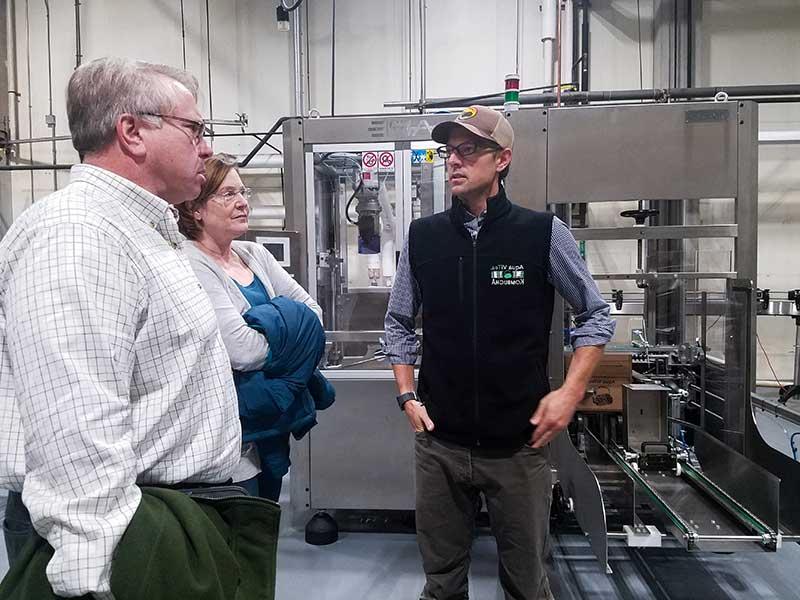 Fred Kenney, ACEDC Executive Director & Elizabeth Burdine, ACEDC Finance Director tour Aqua Vitea's new bottling line with Jordan Benjamin, AquaVitea CFO